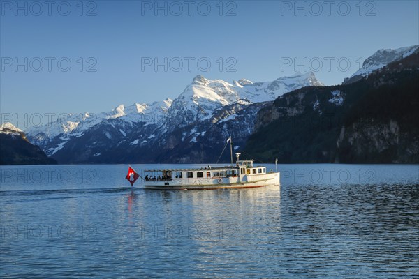 View from Brunnen on a boat on the Lake of Uri in front of the mountain scenery of the Alps of Uri