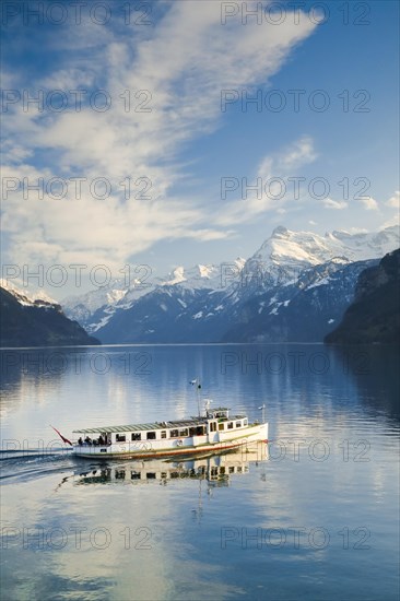 View from Brunnen on a boat on the Lake of Uri in front of the mountain scenery of the Alps of Uri