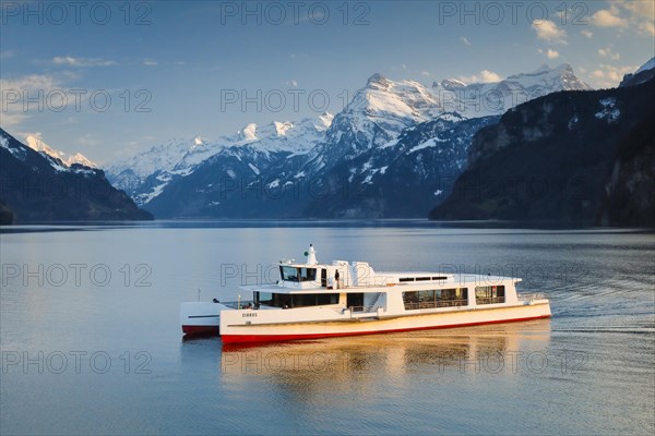 View from Brunnen on a boat on the Lake of Uri in front of the mountain scenery of the Alps of Uri