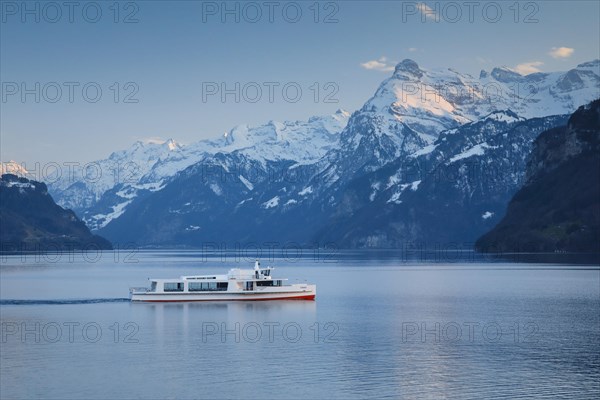 View from Brunnen on a boat on the Lake of Uri in front of the mountain scenery of the Alps of Uri