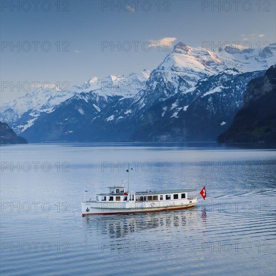 View from Brunnen on a boat on the Lake of Uri in front of the mountain scenery of the Alps of Uri