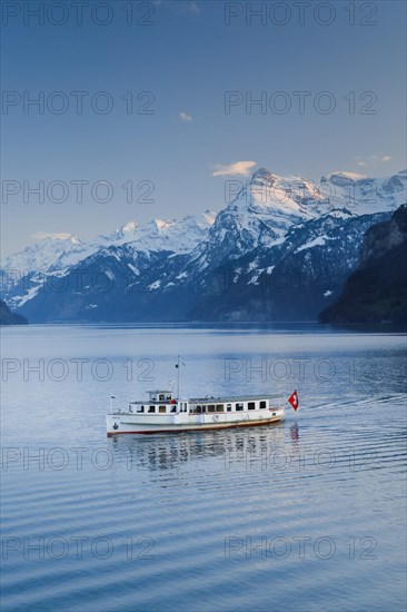 View from Brunnen on a boat on the Lake of Uri in front of the mountain scenery of the Alps of Uri