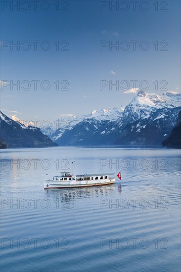 View from Brunnen on a boat on the Lake of Uri in front of the mountain scenery of the Alps of Uri