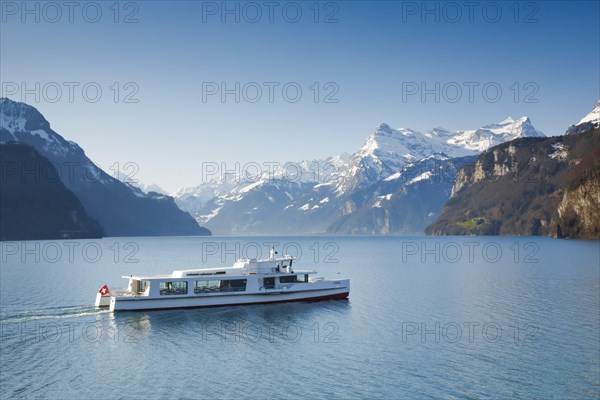 View from Brunnen on a boat on the Lake of Uri in front of the mountain scenery of the Alps of Uri