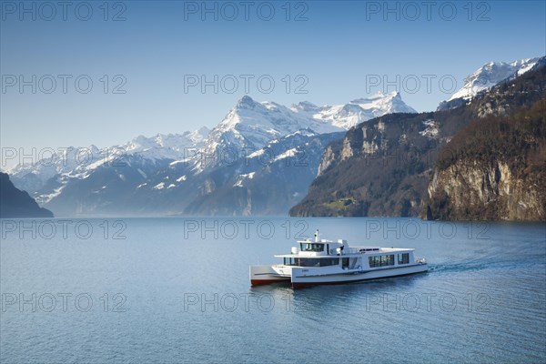 View from Brunnen on a boat on the Lake of Uri in front of the mountain scenery of the Alps of Uri