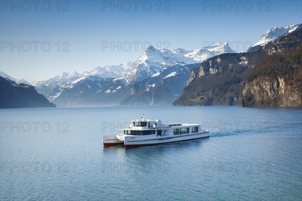 View from Brunnen on a boat on the Lake of Uri in front of the mountain scenery of the Alps of Uri