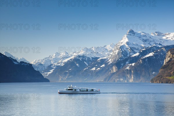 View from Brunnen on a boat on the Lake of Uri in front of the mountain scenery of the Alps of Uri