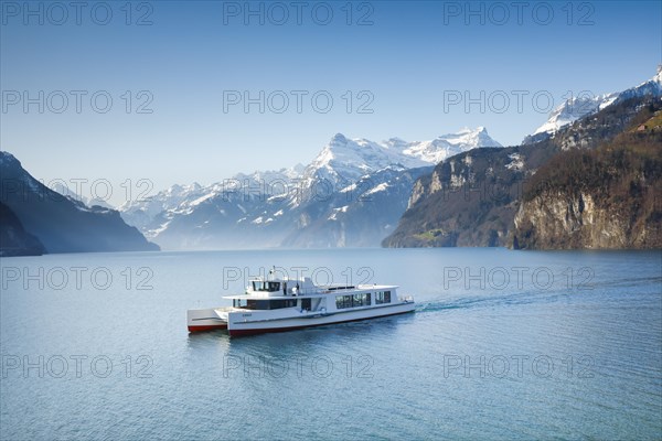 View from Brunnen on a boat on the Lake of Uri in front of the mountain scenery of the Alps of Uri