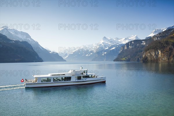 View from Brunnen on a boat on the Lake of Uri in front of the mountain scenery of the Alps of Uri