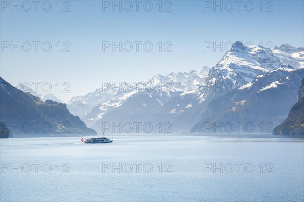 View from Brunnen on a boat on the Lake of Uri in front of the mountain scenery of the Alps of Uri