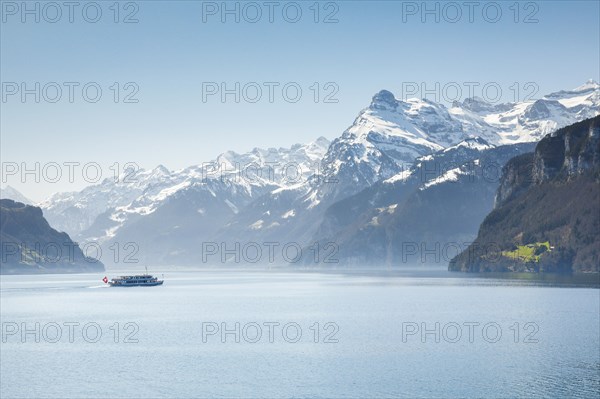 View from Brunnen on a boat on the Lake of Uri in front of the mountain scenery of the Alps of Uri