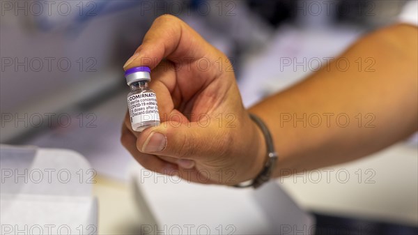 Pharmacist holding Corona vaccine Comirnaty from BioNTech Pfizer