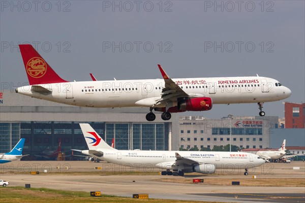 A Juneyao Airlines Airbus A321 with registration number B-8407 at Shanghai Hongqiao Airport