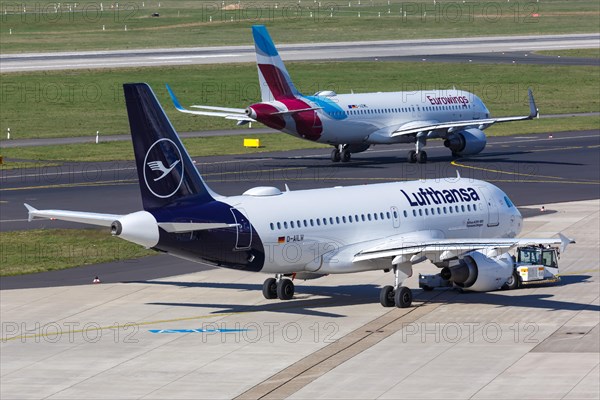 A Lufthansa Airbus A319 with the registration D-AILW and a Eurowings Airbus A320 at Duesseldorf Airport