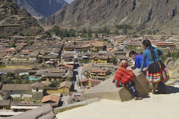 Three indigenous children in the Inca ruins