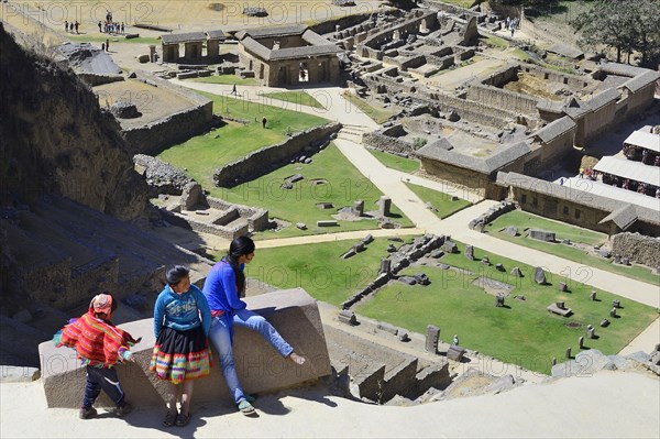 Three indigenous children in the Inca ruins