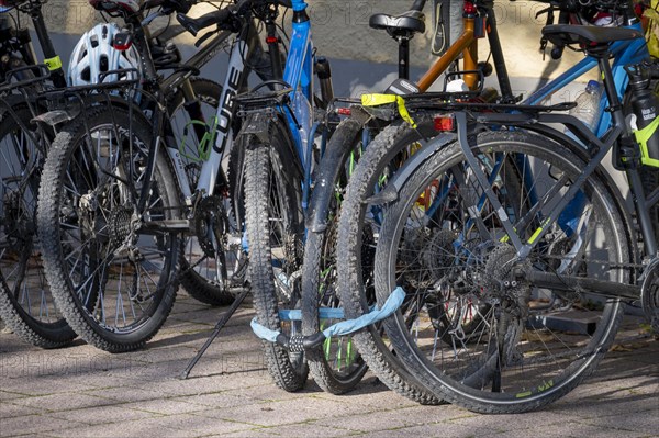 Three bicycles locked with a bicycle lock