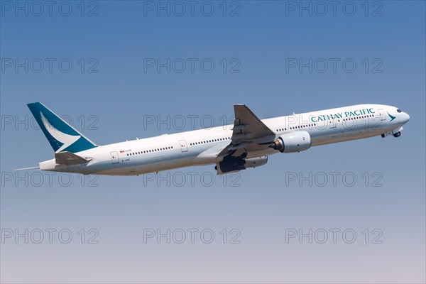 A Cathay Pacific Boeing 777-300 aircraft with registration B-HNE at Hong Kong Airport