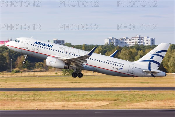 An Airbus A320 of Aegean Airlines with the registration SX-DNC takes off from Berlin-Tegel Airport