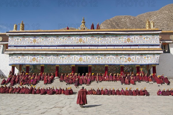 Tibetan monks in monk's robe and yellow cap of the Buddhist Gelukpa school