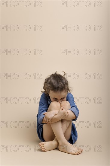 Girl cowering on the floor