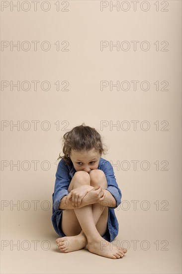 Girl cowering on the floor