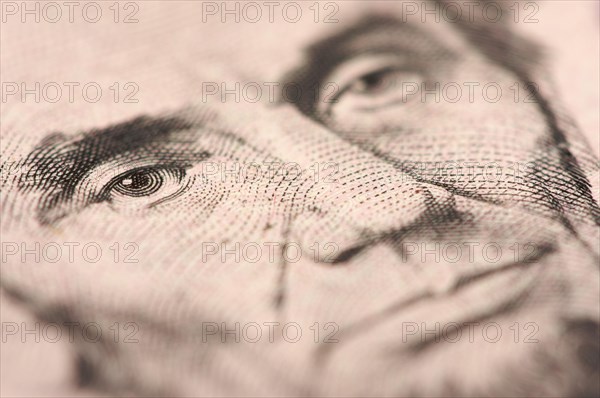 Abstract macro of U.S. five dollar bill's abraham lincoln face with narrow depth of field