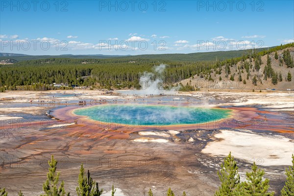 Steaming hot spring with colored mineral deposits and turquoise water