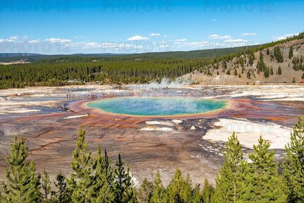 Steaming hot spring with colored mineral deposits and turquoise water