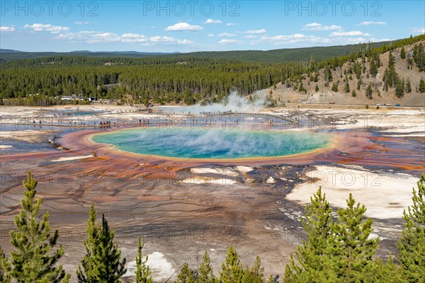 Steaming hot spring with colored mineral deposits and turquoise water