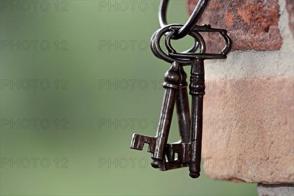 Key ring with old keys hanging on a wall