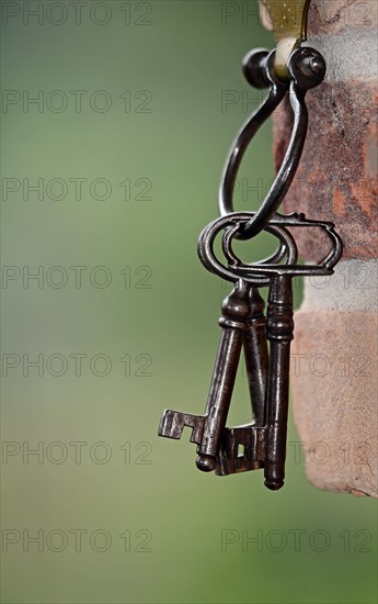 Key ring with old keys hanging on a wall