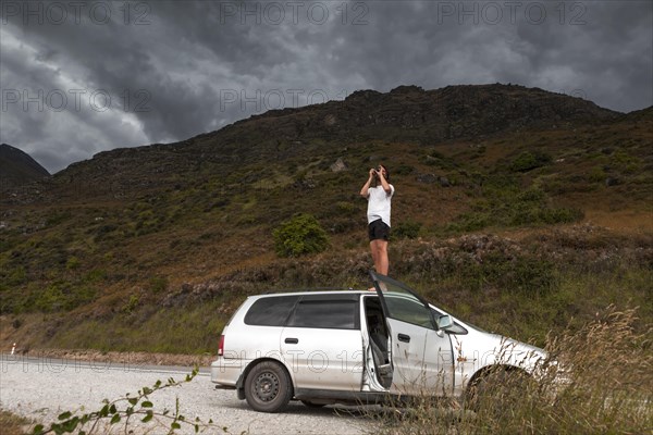 Guy with camera on car roof