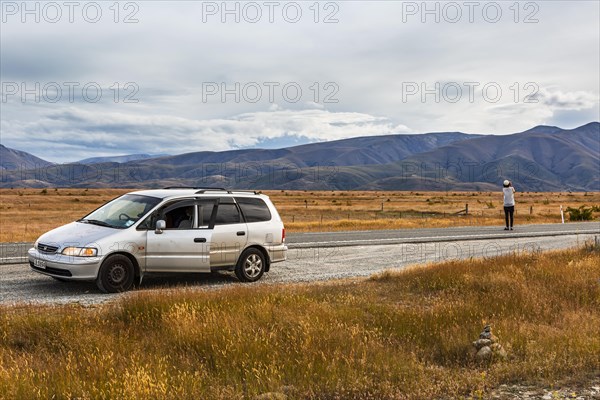 Guy with camera next to car