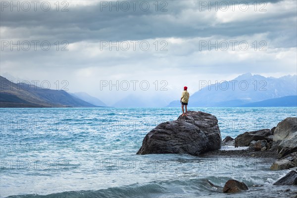 Guy at a beach at Lake Tekapo