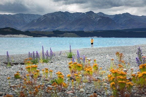 Guy at a beach at Lake Tekapo