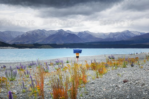 Guy at a beach at Lake Tekapo