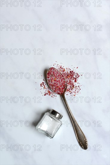 Rose salt in spoon and salt shaker