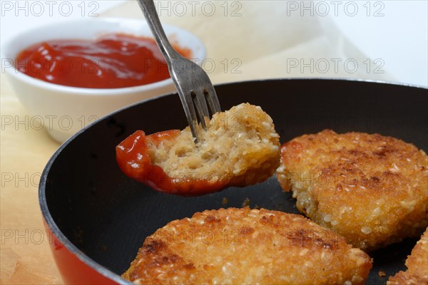 Meat substitute in pan and bowl with ketchup