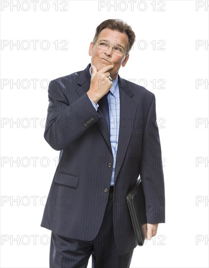 Handsome businessman with hand on chin and looking up and over isolated on a white background