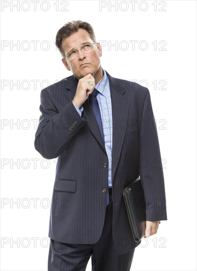 Handsome businessman with hand on chin and looking up and over isolated on a white background