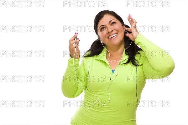 Attractive middle aged hispanic woman in workout clothes with music player and headphones against a white background