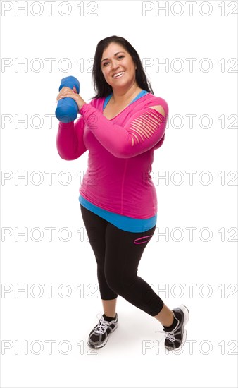 Attractive middle aged hispanic woman in workout clothes lifting dumbbell against a white background