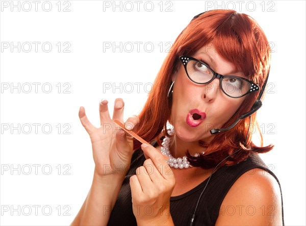 Red haired retro receptionist filing her nails isolated on a white background