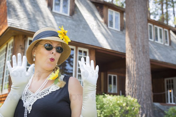 Attractive young woman in twenties outfit near antique house