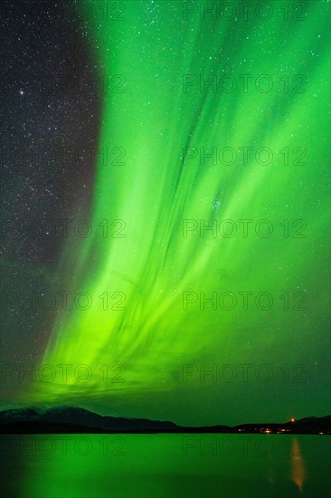 Northern lights above lake Tornetraesk