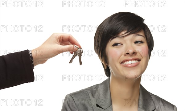 mixed-race young woman being handed keys isolated on a white background