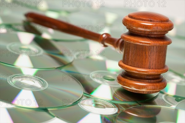 CD rom or DVD discs spread out and gavel