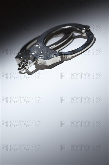 Abstract pair of handcuffs under spot light with room for your own text