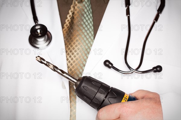 Doctor with stethoscope holding A very big drill